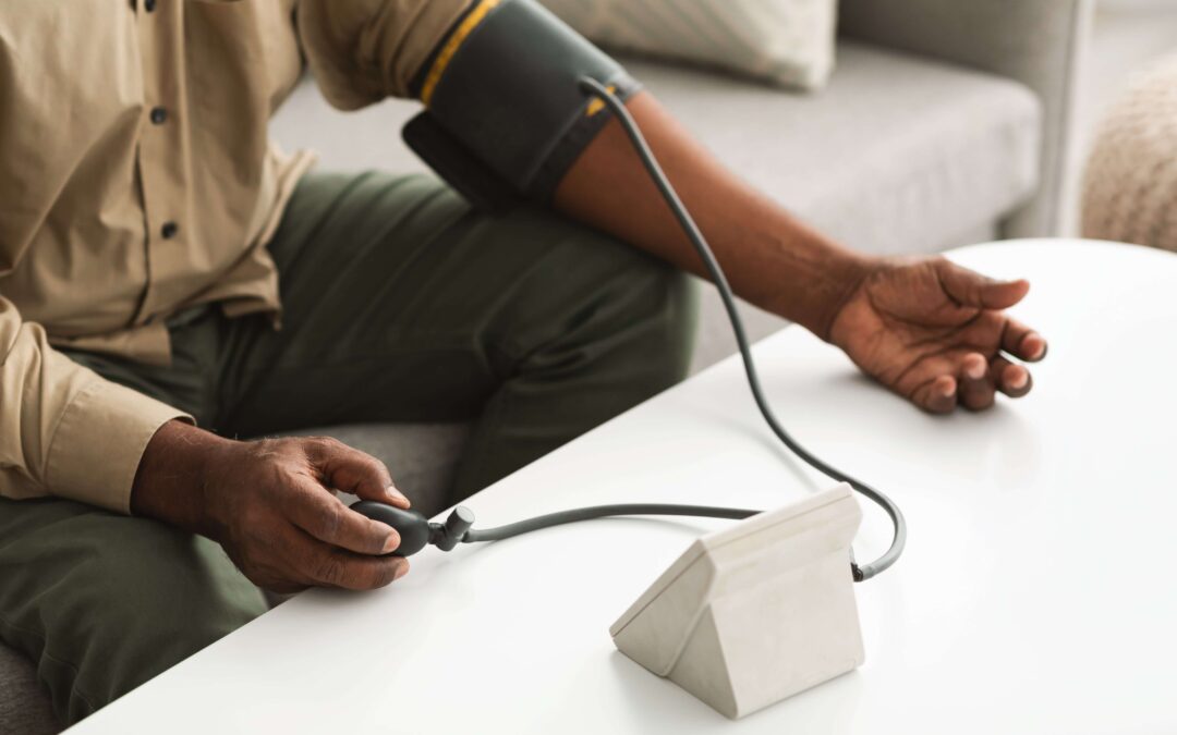 Man using a blood pressure reader to measure his blood pressure